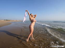 Tattooed blonde Marica Chanel unleashes her great tits while at the beach'