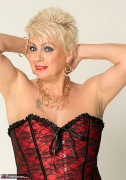 Older lady Dimonty sports short hair during a nude modelling engagement'