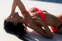 Russian babe Sasha Rose uncovers her fine boobs and poses on a big yacht'