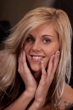 Blonde beauty Sindy Vega wears nothing more than a smile on her pretty face'